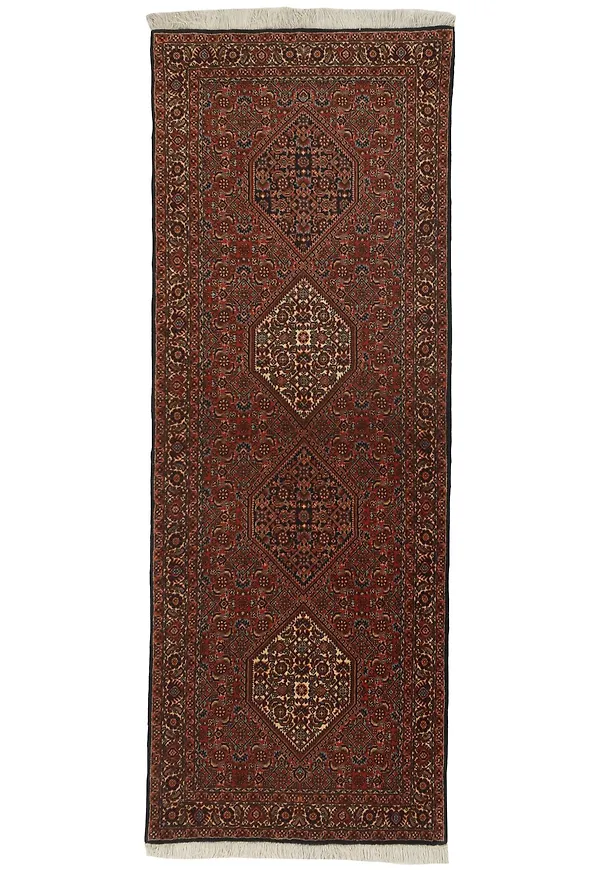 Stilren matta i röd färg gjord i ull.