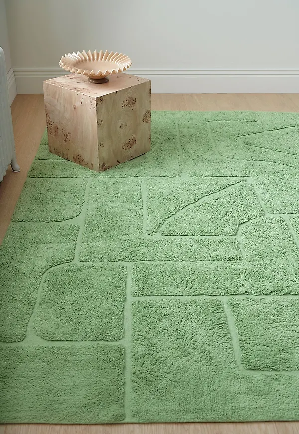 Stilriktig ellos home ellos matta i grön färg gjord i bomull.