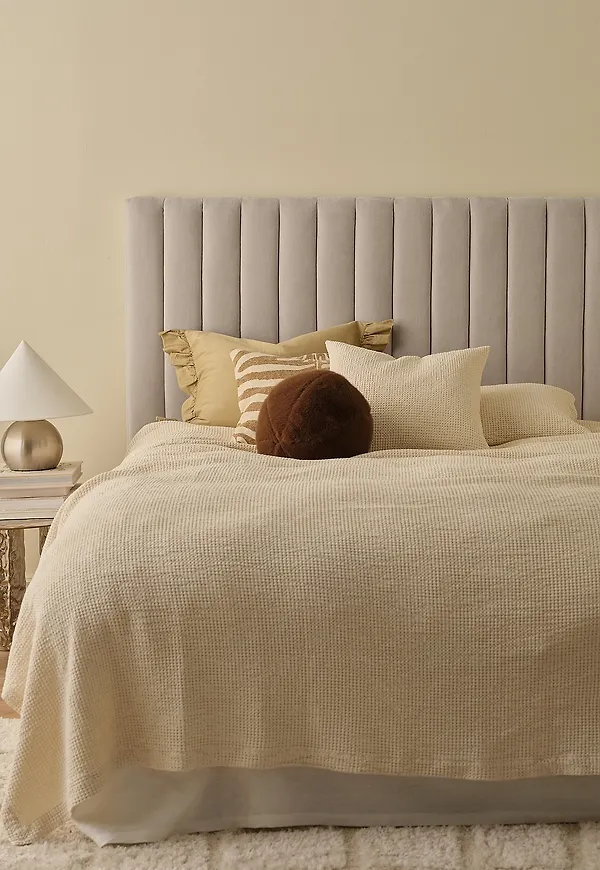 Beige Ellos Home-säng i modern modell.