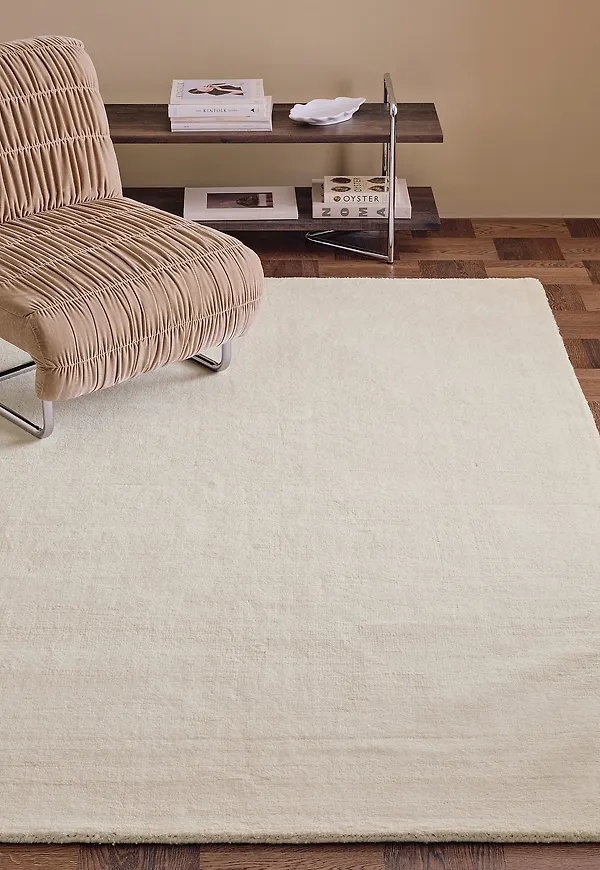 Söt ellos home ellos matta i vit färg gjord i ull.