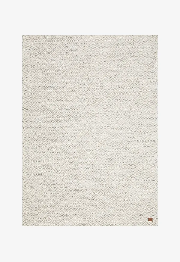 Exklusiv km home matta i beige färg gjord i ull.