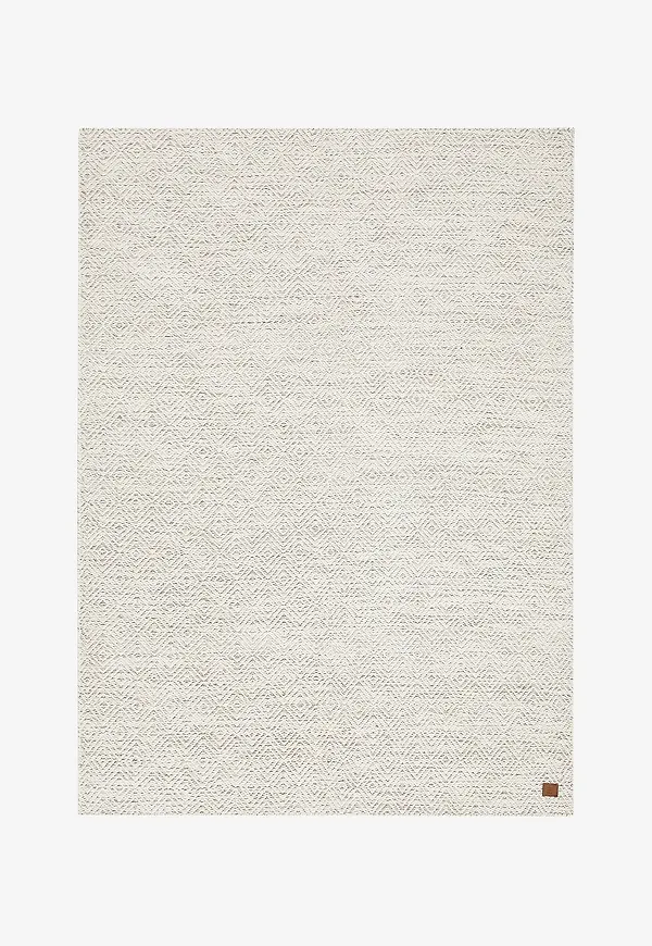 Riktigt snygg km home matta i beige färg gjord i ull.