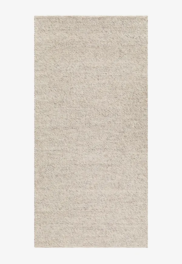 Superfin km home matta i beige färg gjord i ull.