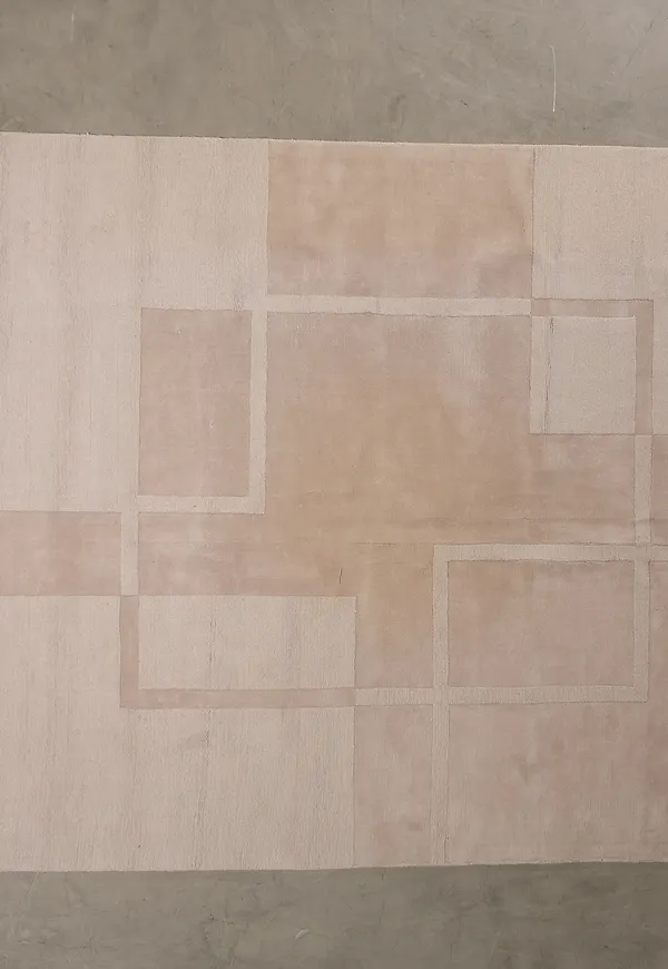 Moderiktig layered matta i vit färg gjord i ull.