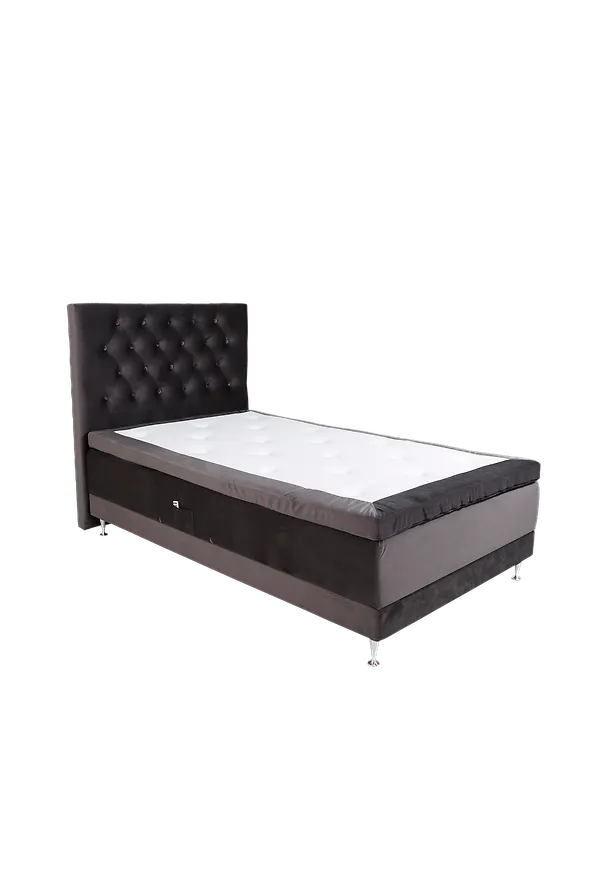 Ikonisk säng i mörkgrå färg gjord i aluminium.