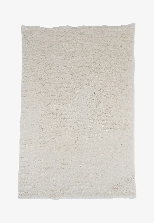 Stilren venture home matta i vit färg gjord i ull.